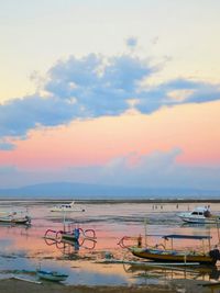 Boat in sea at sunset