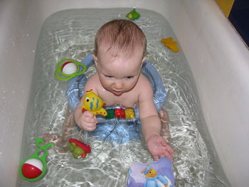 Playful baby in the bathtub