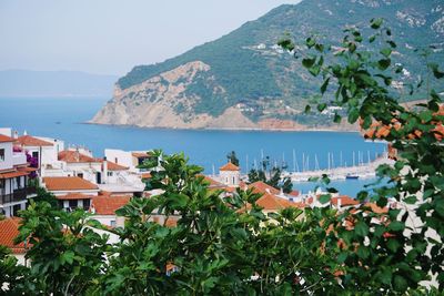 High angle view of townscape by sea against sky