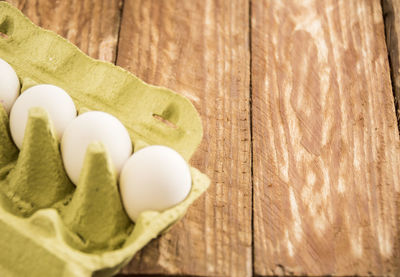 High angle view of eggs and leaves on table