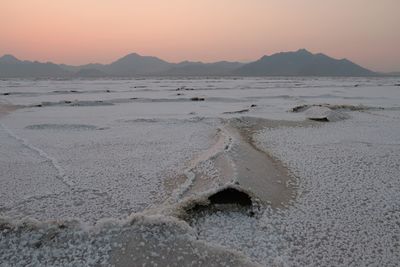 Scenic view of beach against sky during sunset