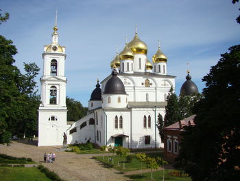 Church by building against sky