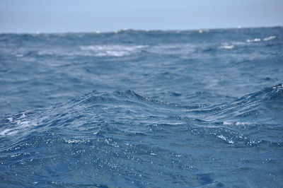 Close-up of sea against blue sky