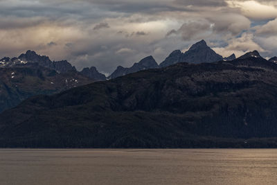 Scenic view of mountains against cloudy sky