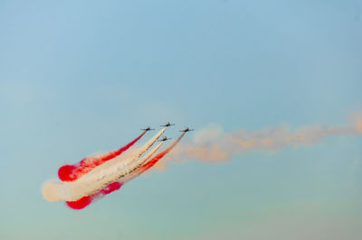 Low angle view of airplane flying against sky