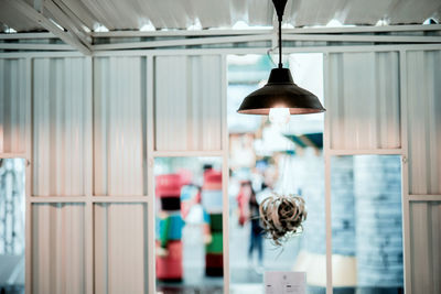 Close-up of illuminated pendant light hanging from ceiling