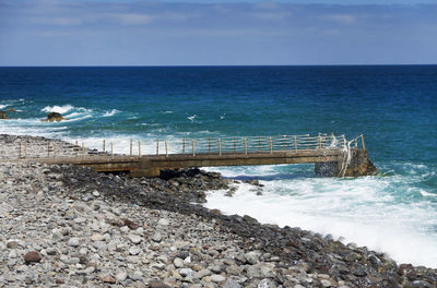 Side view of jetty at calm blue sea