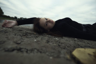 Portrait of young woman lying on beach