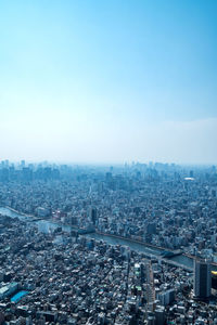 High angle view of city buildings against clear sky