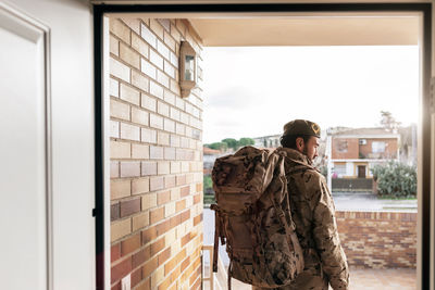 Full length of man standing in front of window