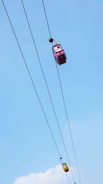 Low angle view of kite hanging against clear blue sky