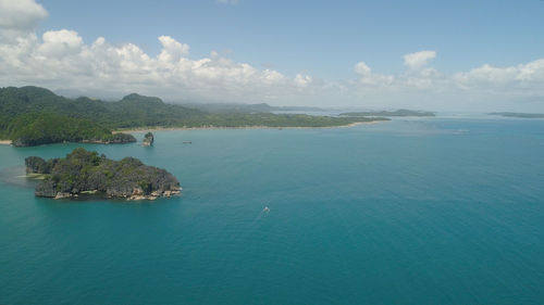Aerial view of groups islands with sand beach and turquoise water in blue lagoon among coral reefs