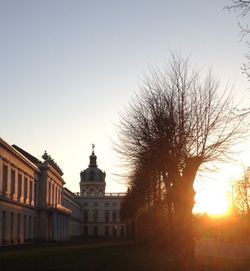 Buildings against clear sky at sunset