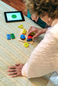 High angle view of woman playing with toy on table