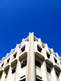 Low angle view of building against clear blue sky