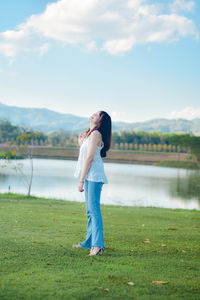 Rear view of woman standing on field