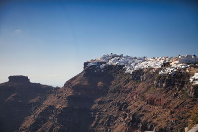 Low angle view of mountain against clear blue sky