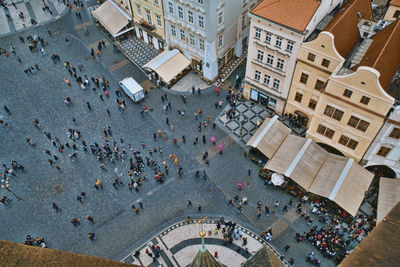 High angle view of people walking on street amidst buildings in city