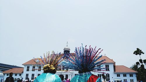 Close-up of art decors against clear sky in city