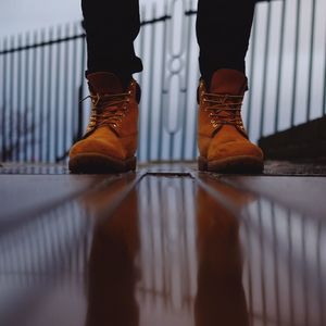 Low section of woman standing on tiled floor