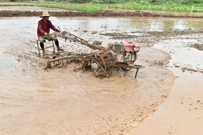 High angle view of man working in lake