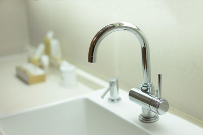 Close-up of faucet in bathroom