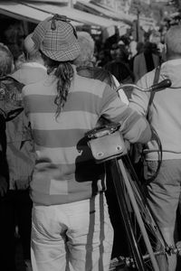 Rear view of people standing outdoors