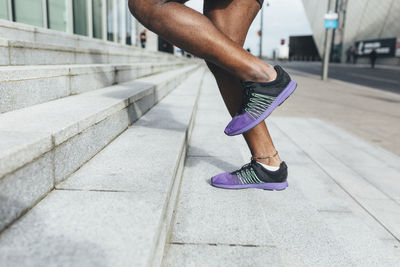 Close-up of man running up stairs