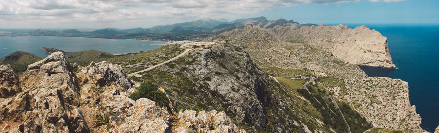 Panoramic view of sea and mountains against sky