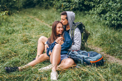 Young couple kissing on grass