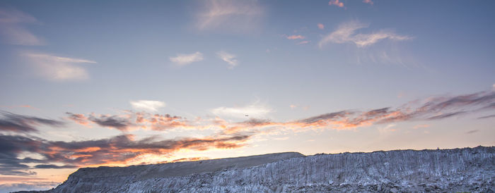Scenic view of mountains against sky at sunset