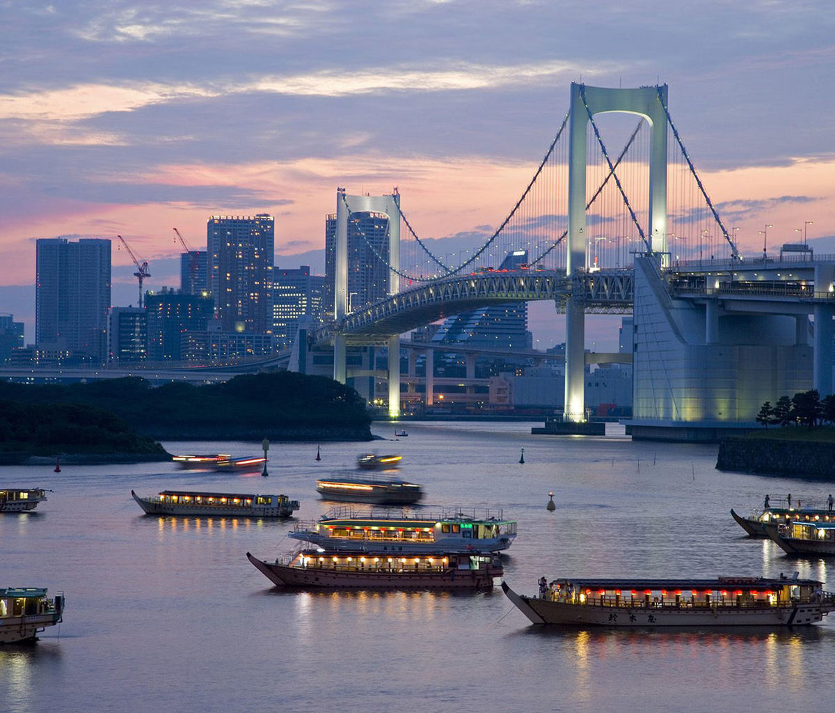 architecture, built structure, water, transportation, waterfront, sunset, river, nautical vessel, sky, city, bridge - man made structure, building exterior, connection, mode of transport, illuminated, harbor, cloud - sky, boat, dusk, moored