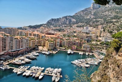 High angle view of buildings by sea against sky