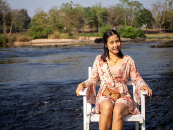 Young woman sitting outdoors