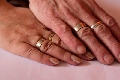 Cropped image of hands wearing rings