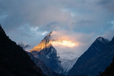 Scenic view of snowcapped mountains against sky during sunset