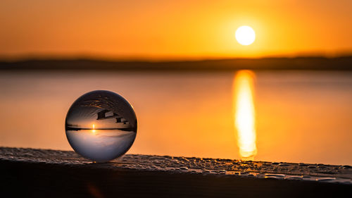 Close-up of sea against sky during sunset