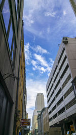 Low angle view of building against cloudy sky