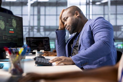 Side view of man working at office