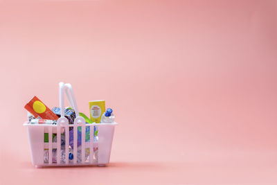 High angle view of multi colored toys against pink background