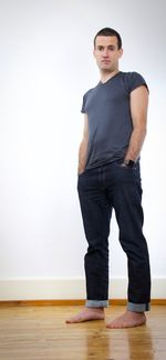 Portrait of young man standing on hardwood floor