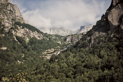 Scenic view of mountains against cloudy sky