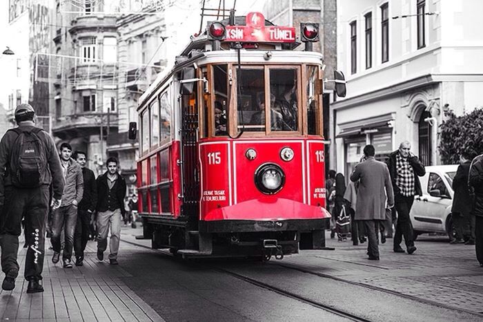 architecture, building exterior, built structure, transportation, men, city, mode of transport, land vehicle, street, person, city life, walking, red, travel, public transportation, lifestyles, car, full length, incidental people