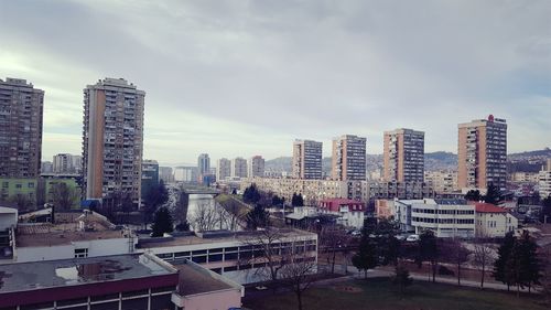 View of cityscape against cloudy sky