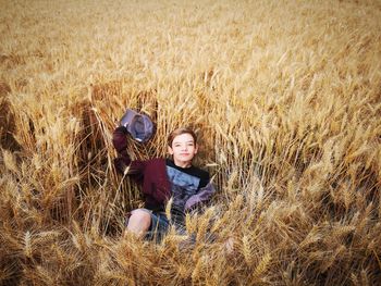 Portrait of boy sitting on field