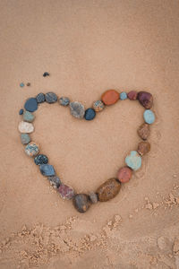 High angle view of heart shape on sand at beach