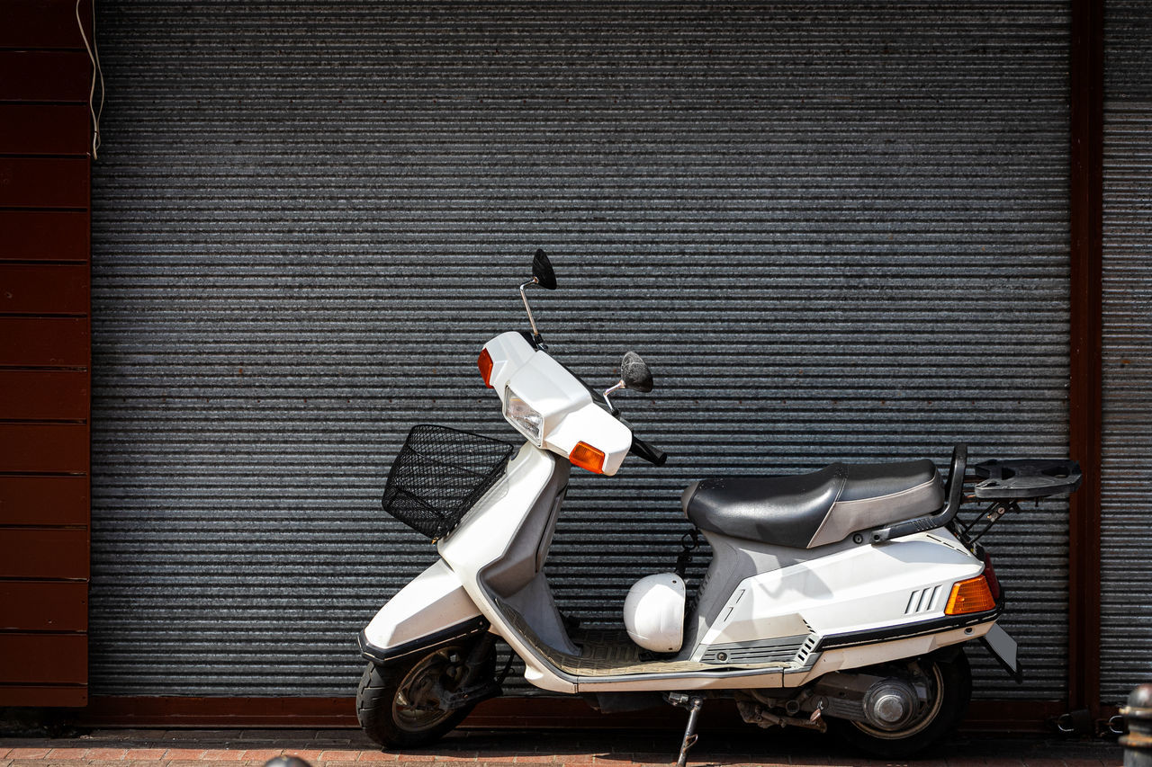 MOTOR SCOOTER PARKED ON WALL
