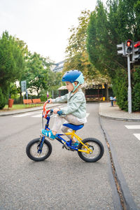 Boy riding push scooter on road