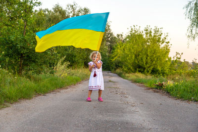 Rear view of woman holding umbrella