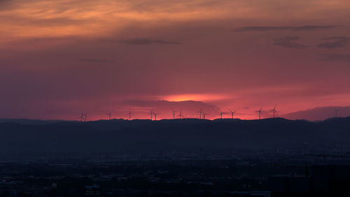 Scenic view of silhouette landscape against romantic sky at sunset